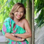 Woman in a colorful dress smiling outdoors in Lawaan, Philippines.