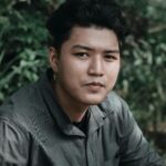 Portrait of a young man outdoors in a stylish green shirt, set in Muntinlupa, NCR, Philippines.